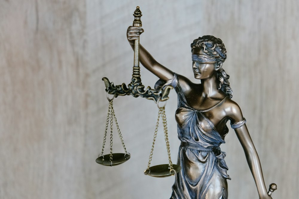 Scales of justice and legal precedent volumes in courthouse